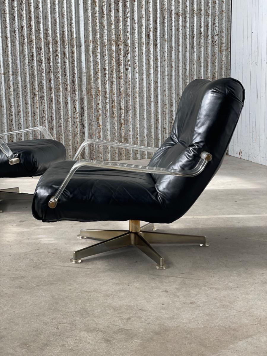 Pair space age black leather and plexiglass swivel chairs 1970s