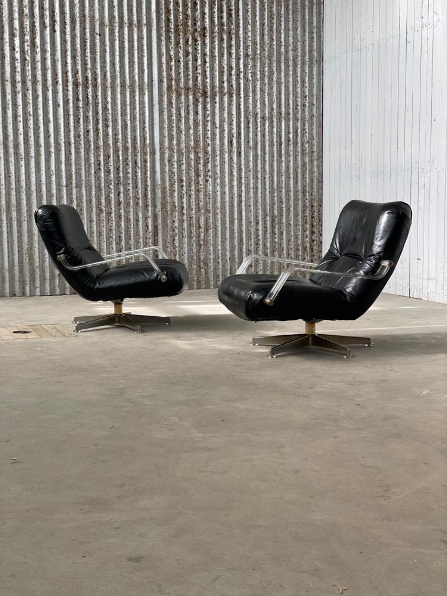 Pair space age black leather and plexiglass swivel chairs 1970s