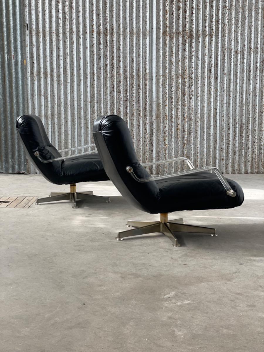 Pair space age black leather and plexiglass swivel chairs 1970s