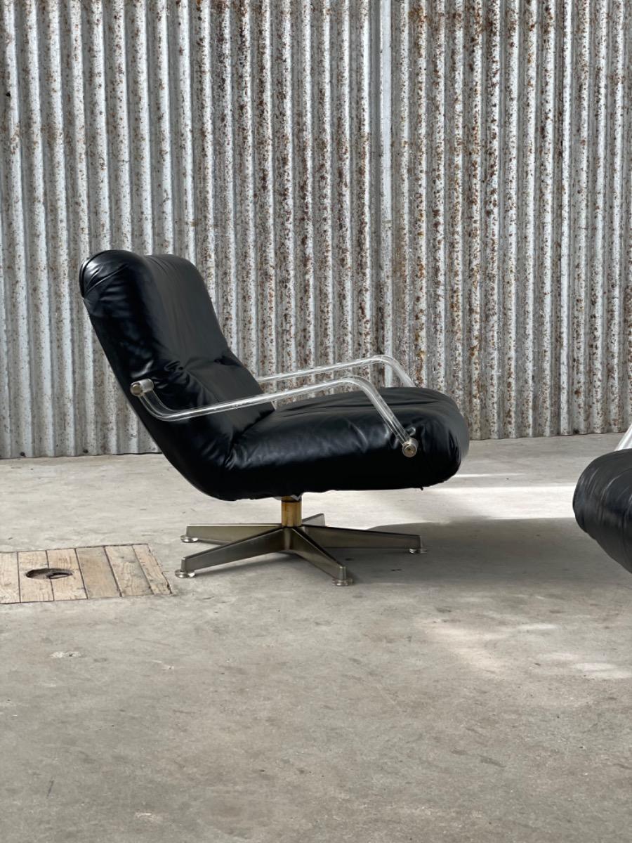 Pair space age black leather and plexiglass swivel chairs 1970s