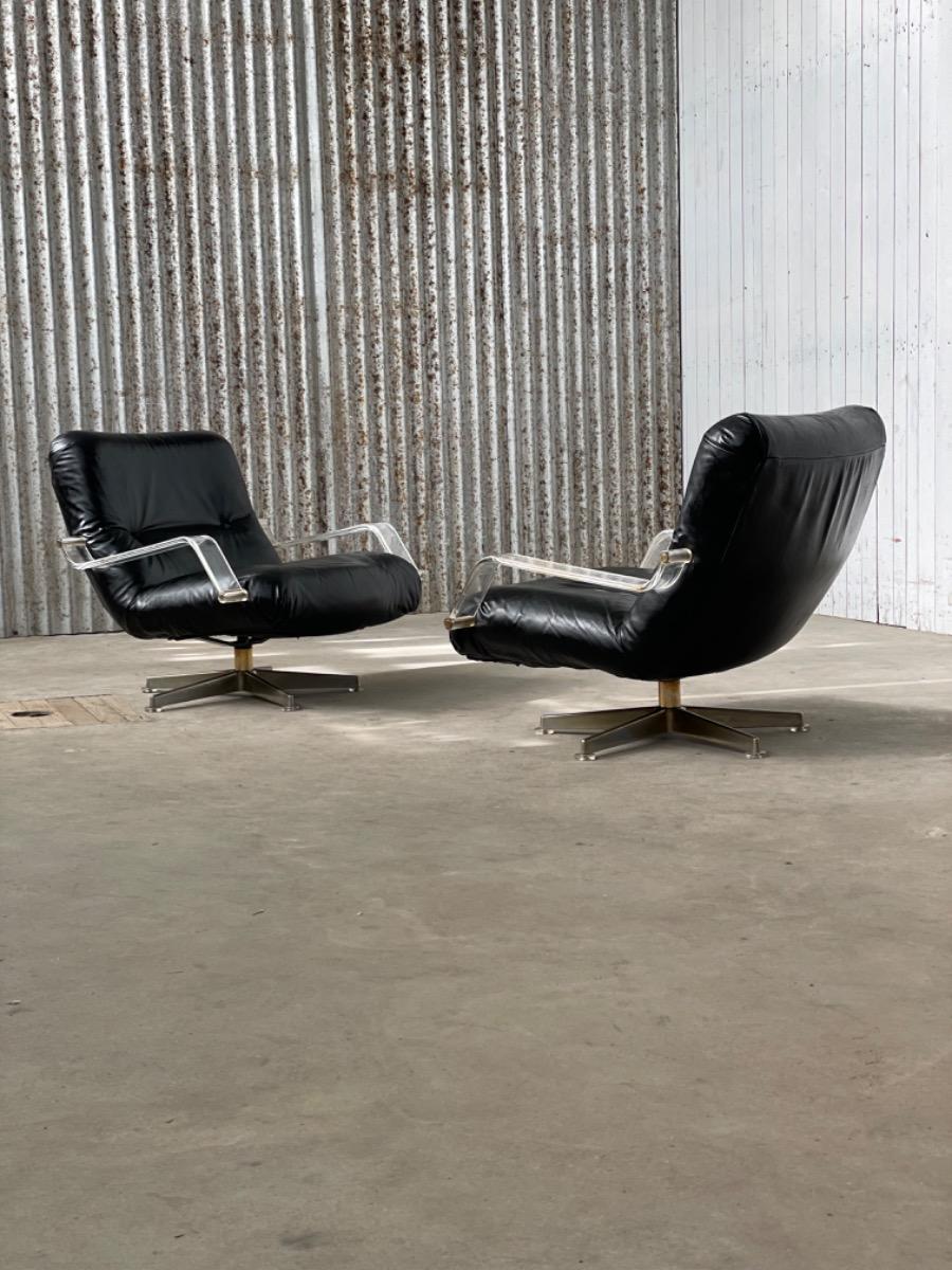 Pair space age black leather and plexiglass swivel chairs 1970s