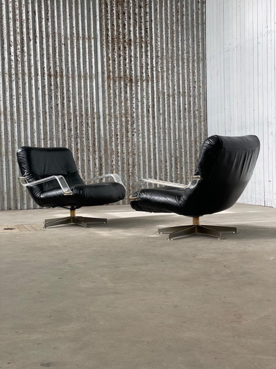 Pair space age black leather and plexiglass swivel chairs 1970s