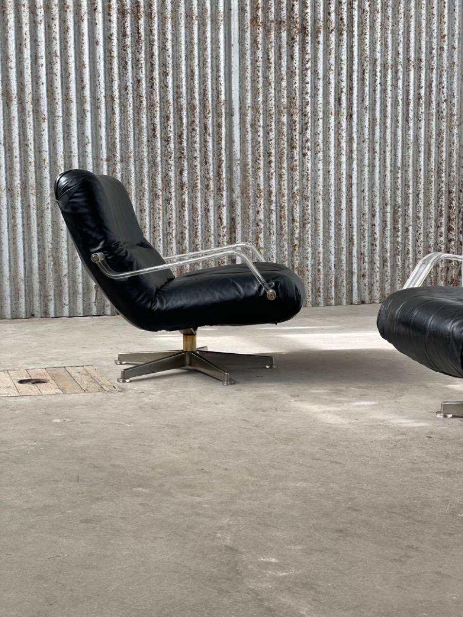 Pair space age black leather and plexiglass swivel chairs 1970s