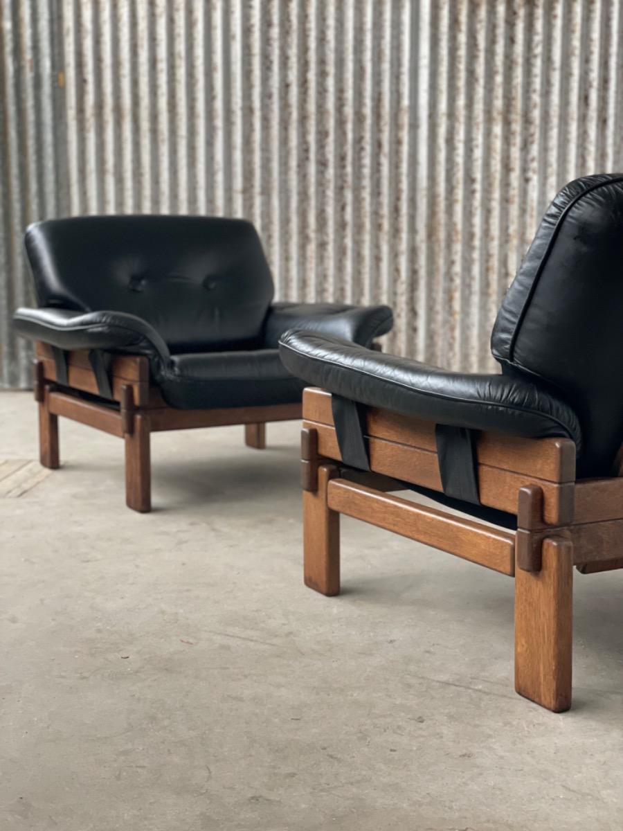 Set Brutalist oak armchairs in Black leather with ottoman, 1960