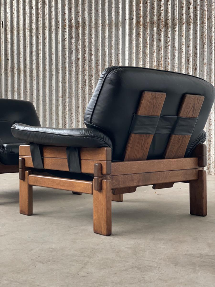 Set Brutalist oak armchairs in Black leather with ottoman, 1960